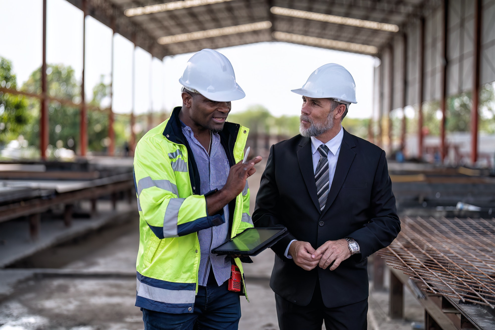 At construction site manager meet engineer check precast concrete slabs and steel rebar preparation